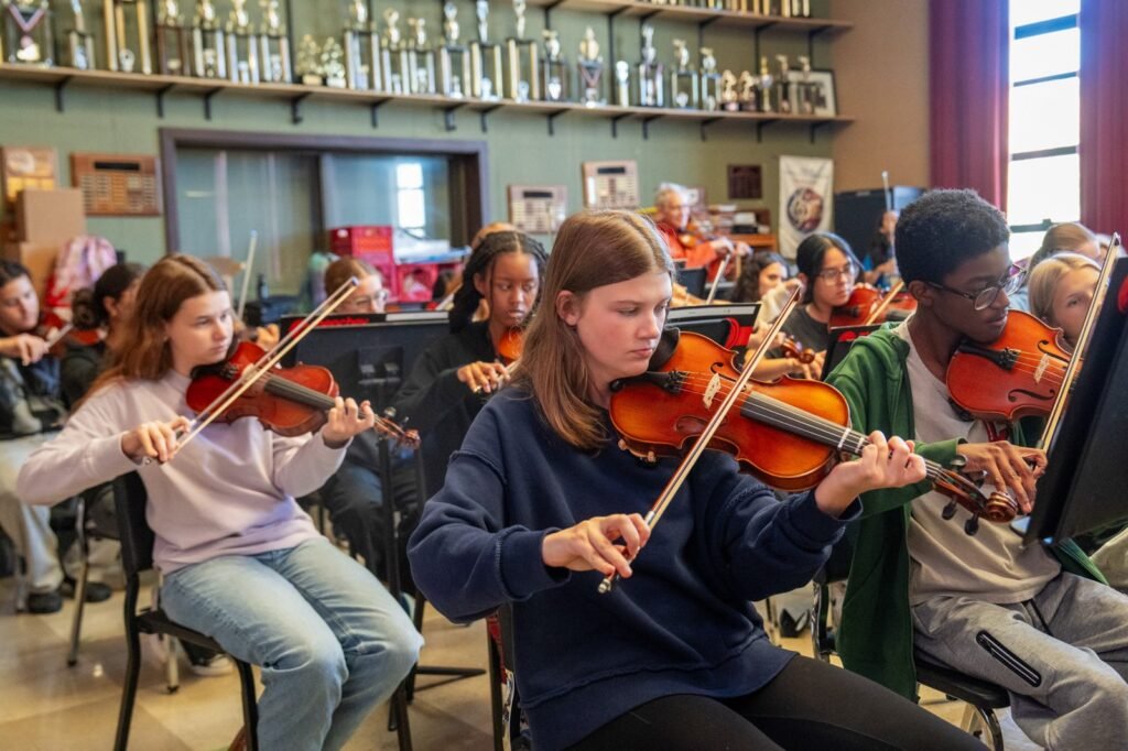 Students playing violins together during the Redemption Time residency at McCaskey High School in Lancaster
